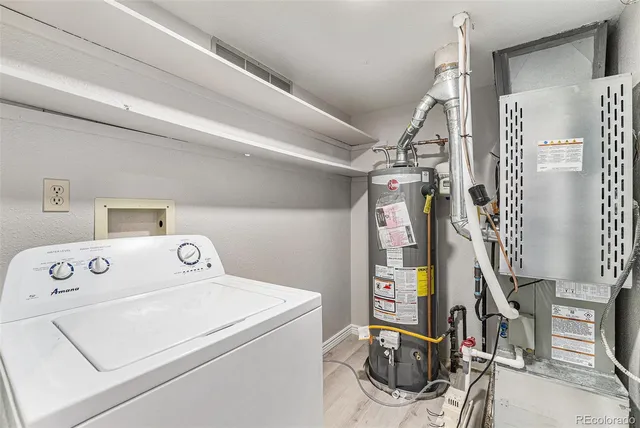 a utility room with dryer washer and other items