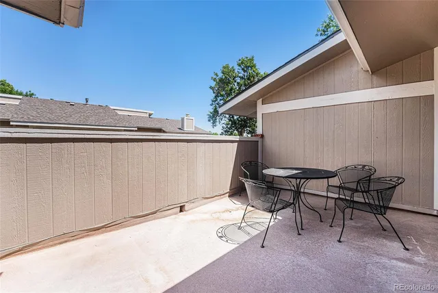 a backyard of a house with table and chairs
