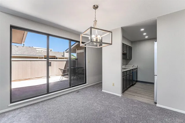a view of a kitchen with a sink and refrigerator in a room