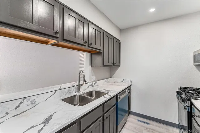 a kitchen with a sink cabinets and entryway