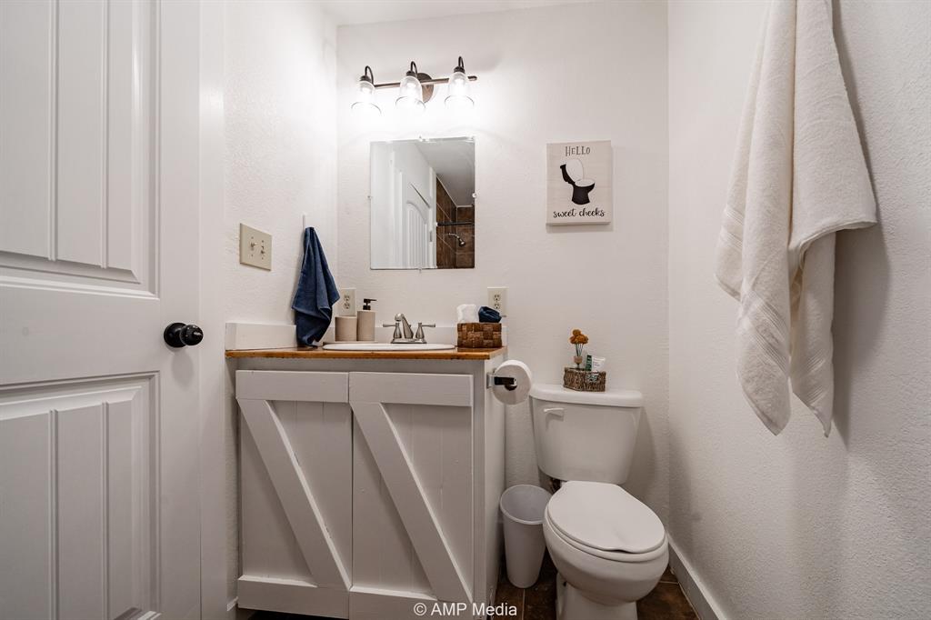 941 Harold Street Albany, TX 76430 - Photo 17 of 22 a white toilet sitting next to a bathroom sink