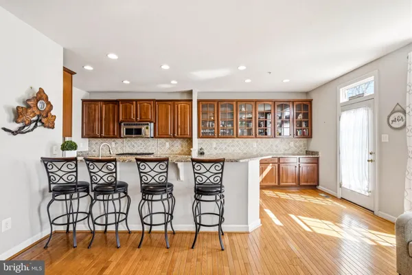 a view of a kitchen with granite countertop a refrigerator and a sink