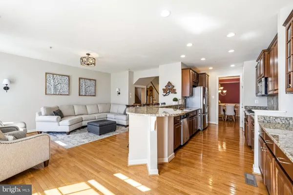 a kitchen with stainless steel appliances granite countertop a stove and a sink