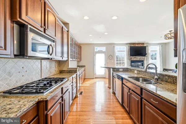 a kitchen with stainless steel appliances granite countertop a stove and a refrigerator