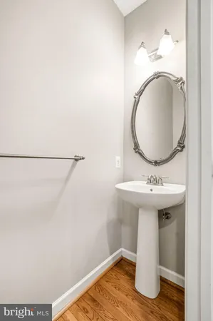 a view of a hallway with white walls and stairs