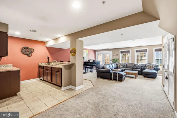 a living room with furniture a window and a flat screen tv