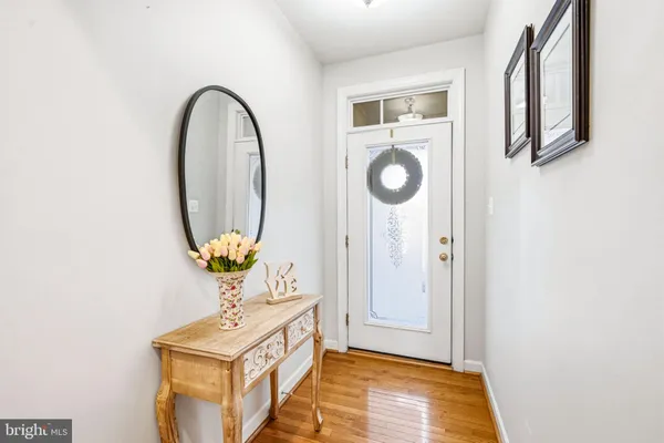 a view of entryway and hall with wooden floor