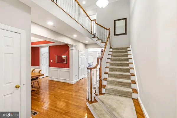 a view of entryway and hall with wooden floor