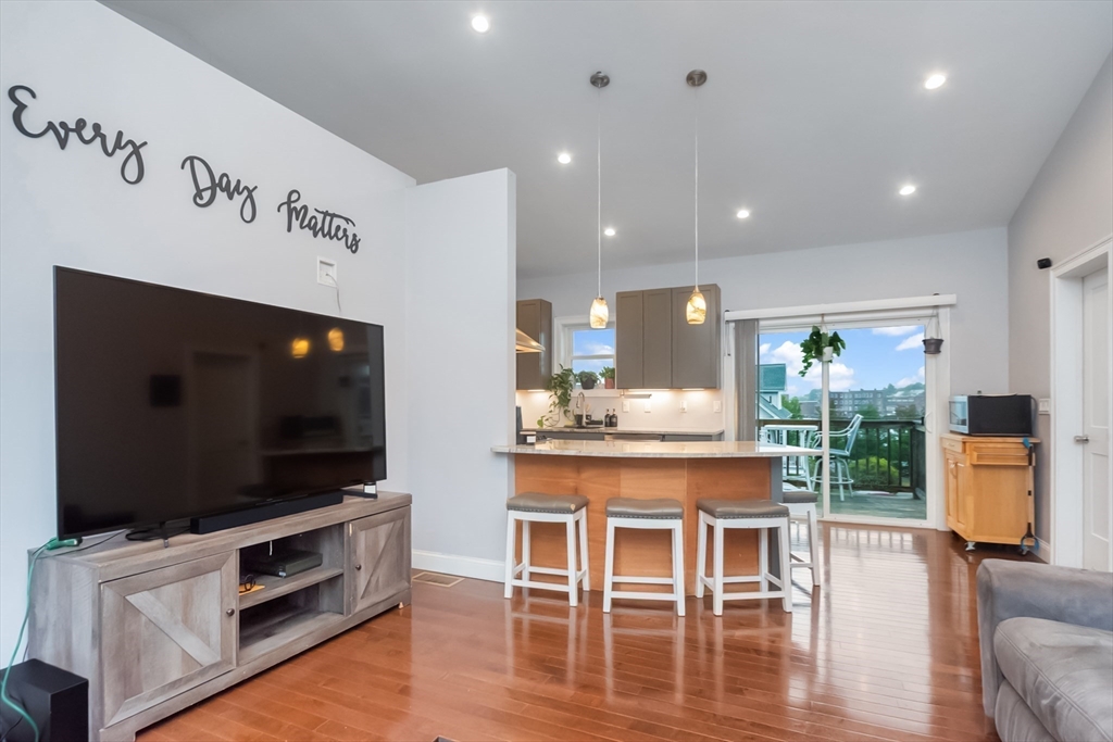 38 Norman Street Clinton, MA 01510 - Photo 11 of 40 a living room with furniture a flat screen tv and wooden floor