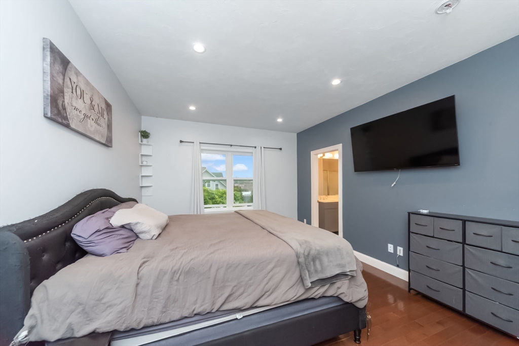 38 Norman Street Clinton, MA 01510 - Photo 14 of 40 a bedroom with a bed and a flat screen tv