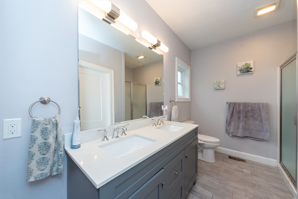 38 Norman Street Clinton, MA 01510 - Photo 16 of 40 a bathroom with a sink double vanity granite and a mirror