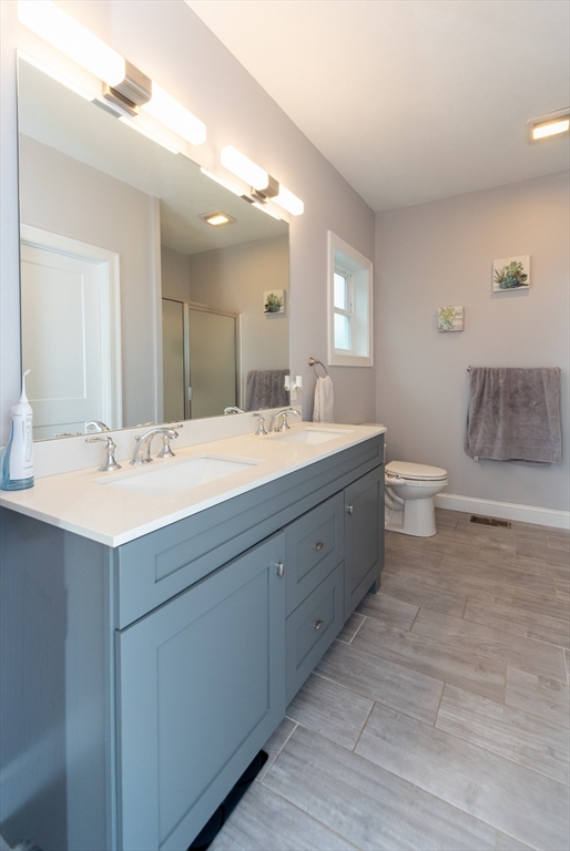 38 Norman Street Clinton, MA 01510 - Photo 17 of 40 a bathroom with a double vanity sink mirror and toilet