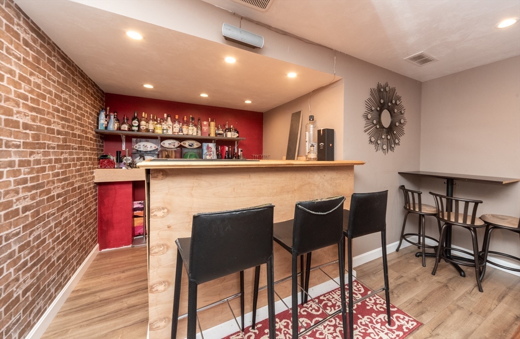 38 Norman Street Clinton, MA 01510 - Photo 22 of 40 a kitchen with a dining table chairs and a refrigerator