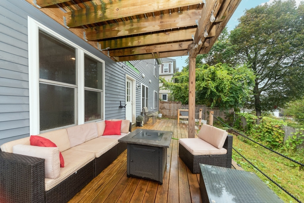 38 Norman Street Clinton, MA 01510 - Photo 23 of 40 a balcony with wooden floor and outdoor seating