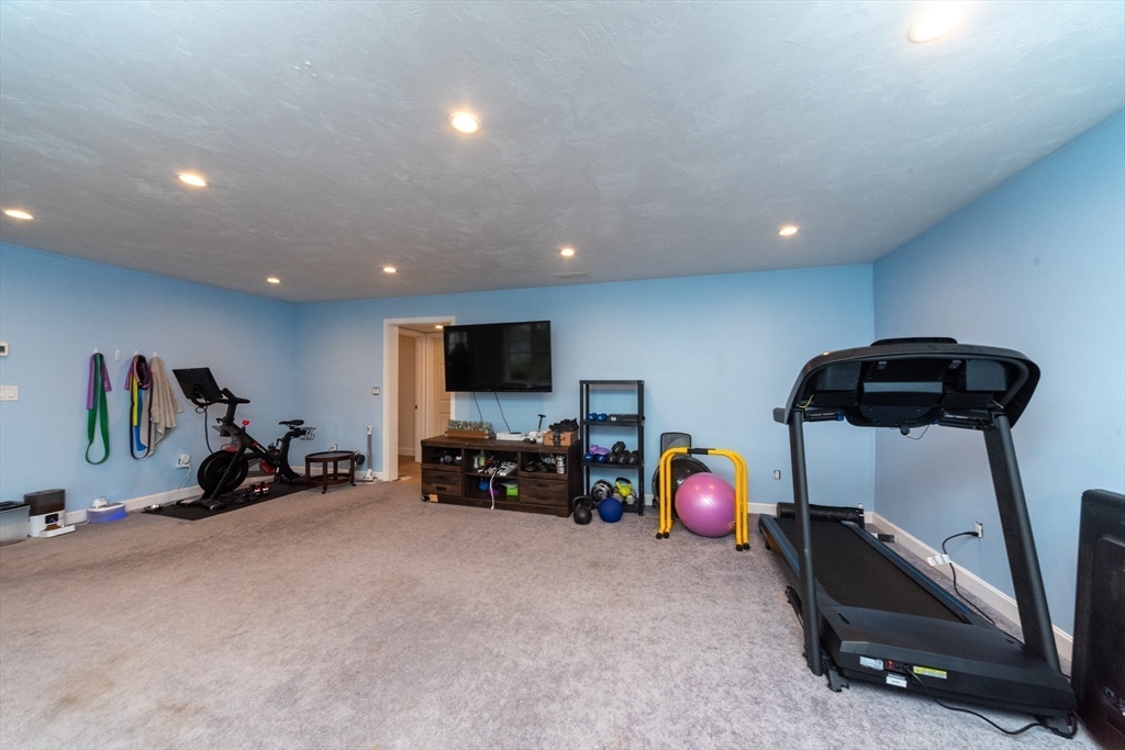 38 Norman Street Clinton, MA 01510 - Photo 27 of 40 a bedroom with furniture and a flat screen tv