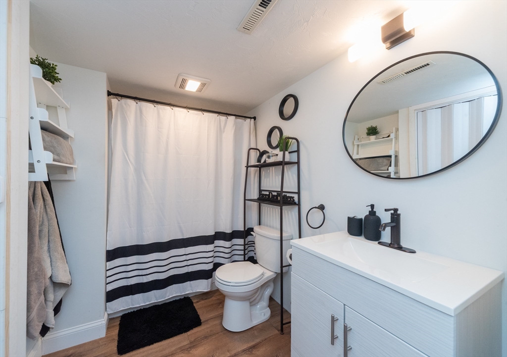 38 Norman Street Clinton, MA 01510 - Photo 29 of 40 a bathroom with a toilet a sink and a mirror