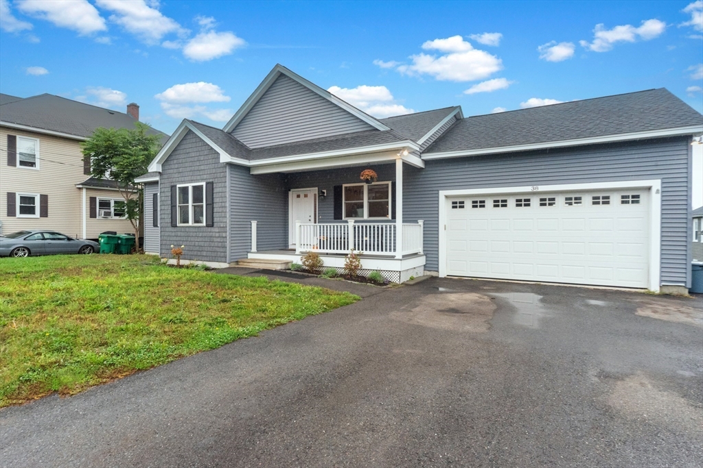 38 Norman Street Clinton, MA 01510 - Photo 36 of 40 a view of a house with a yard and garage