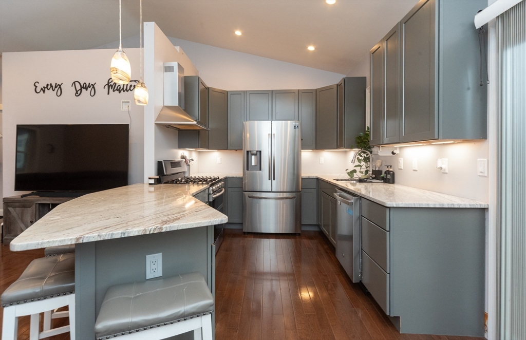 38 Norman Street Clinton, MA 01510 - Photo 6 of 40 a kitchen with stainless steel appliances kitchen island granite countertop a stove a sink and a microwave