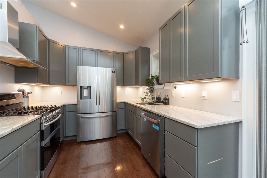 38 Norman Street Clinton, MA 01510 - Photo 7 of 40 a kitchen with a sink stainless steel appliances and cabinets