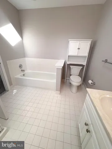 a bathroom with a bathtub and toilet