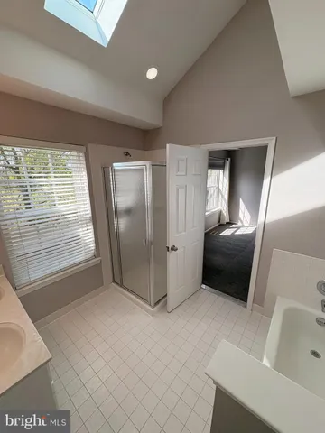 a view of hallway with cabinets and refrigerator
