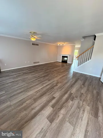 a view of a room with wooden floor and a window