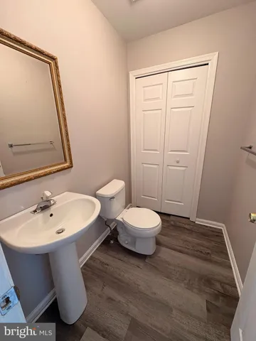 a bathroom with a sink toilet and mirror