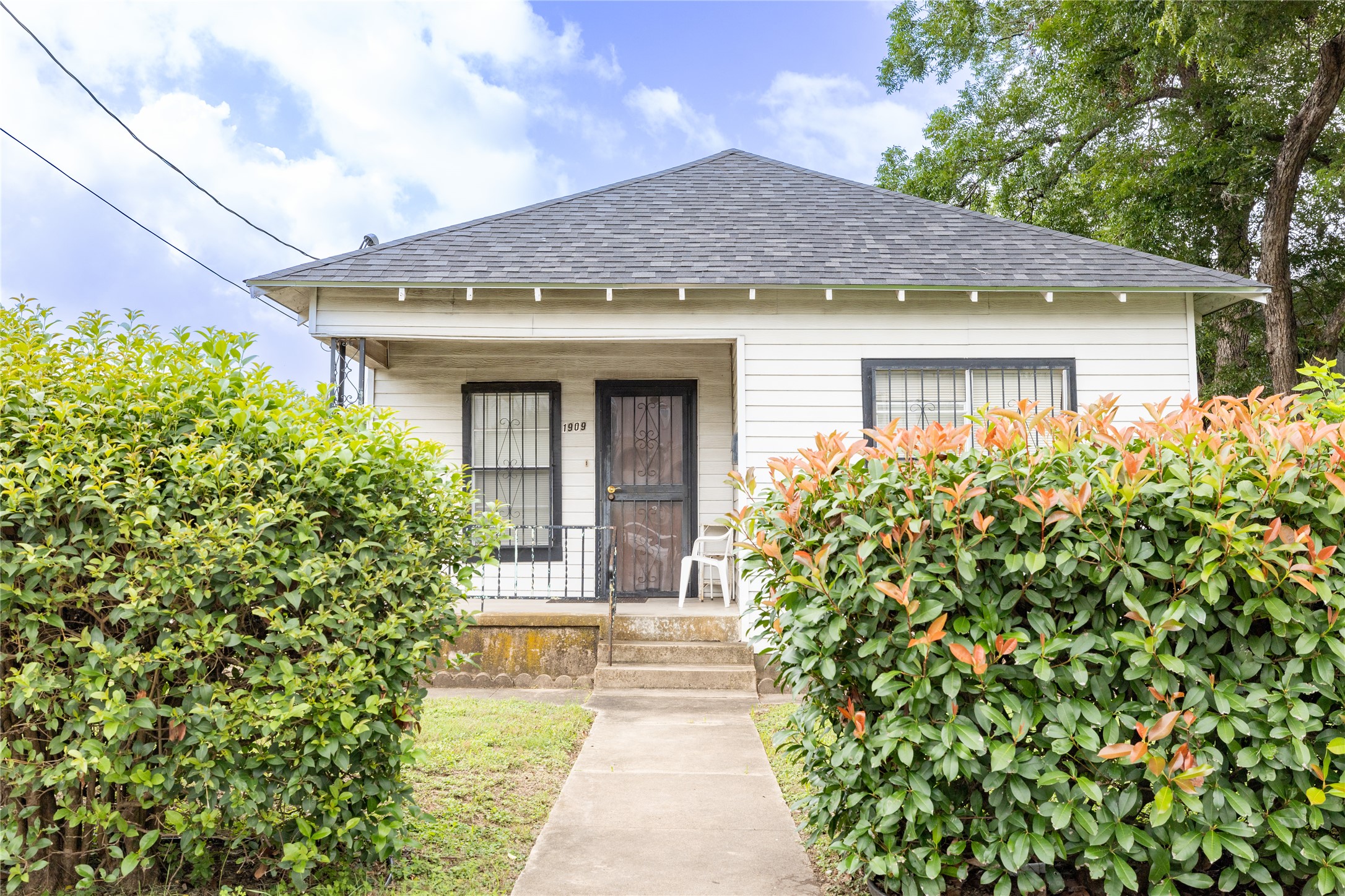 1909 East 14th Street Austin, TX 78702 - Photo 1 of 1 a front view of a house with a garden