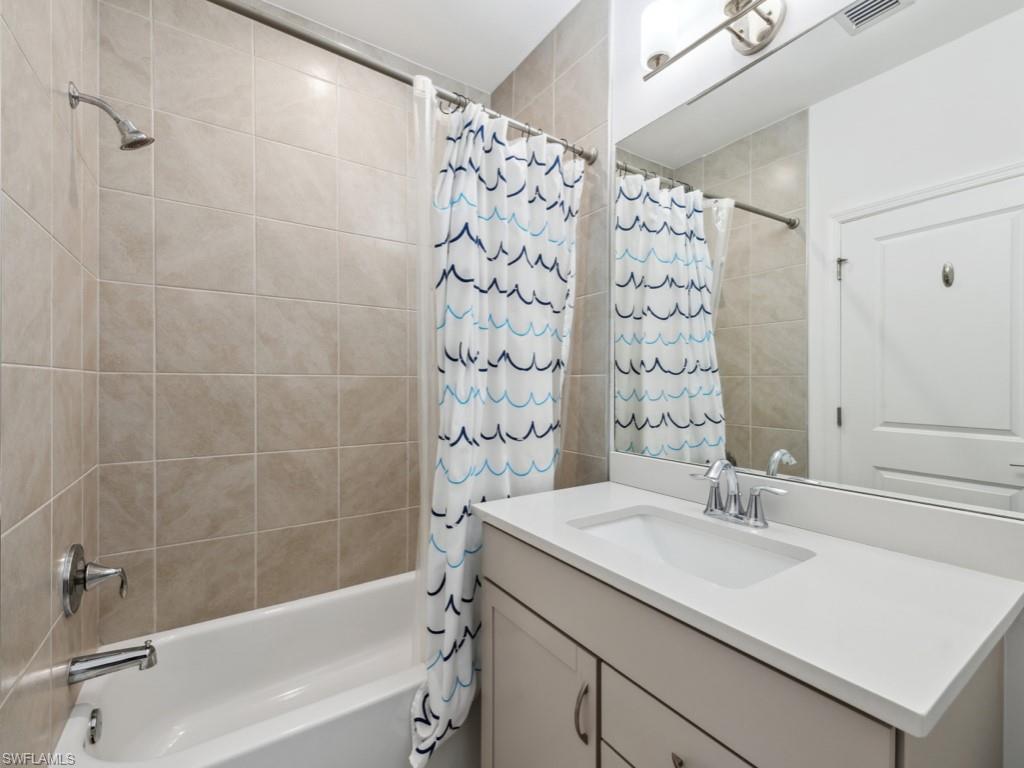 7591 Morgan Way Naples, FL 34119 - Photo 11 of 27 Bathroom with vanity and shower / tub combo