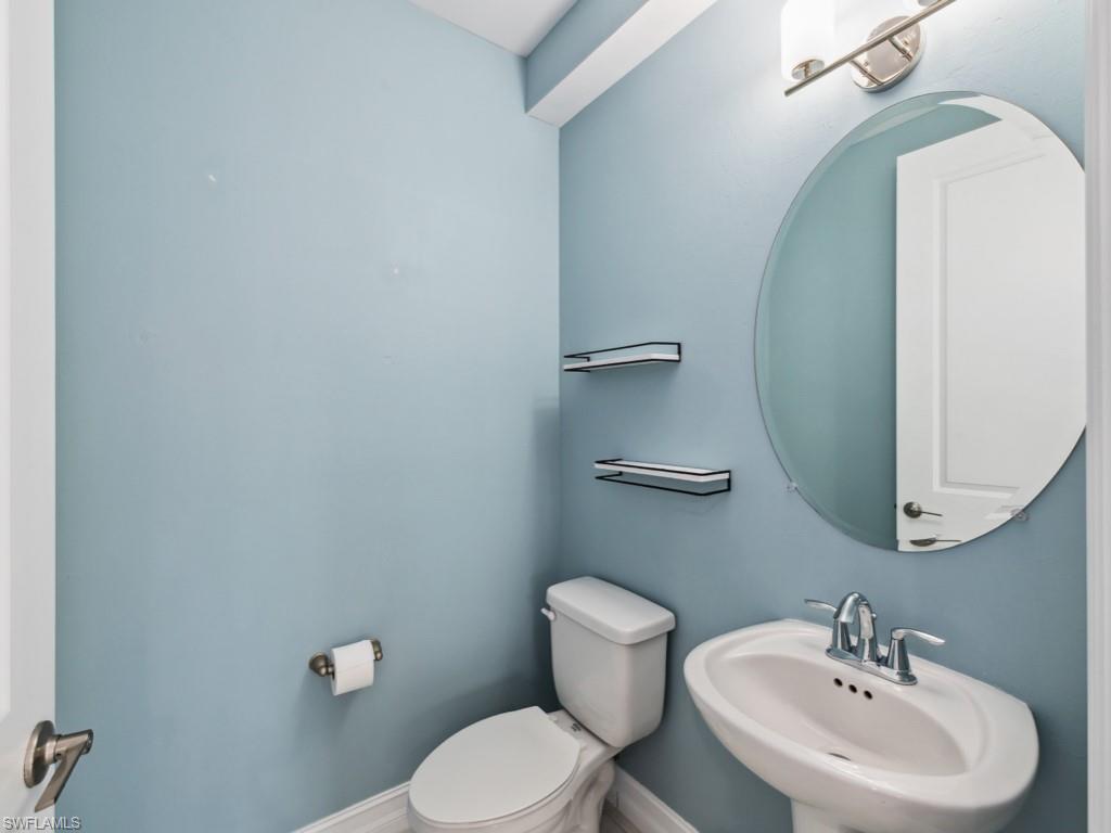 7591 Morgan Way Naples, FL 34119 - Photo 13 of 27 Bathroom with sink and toilet