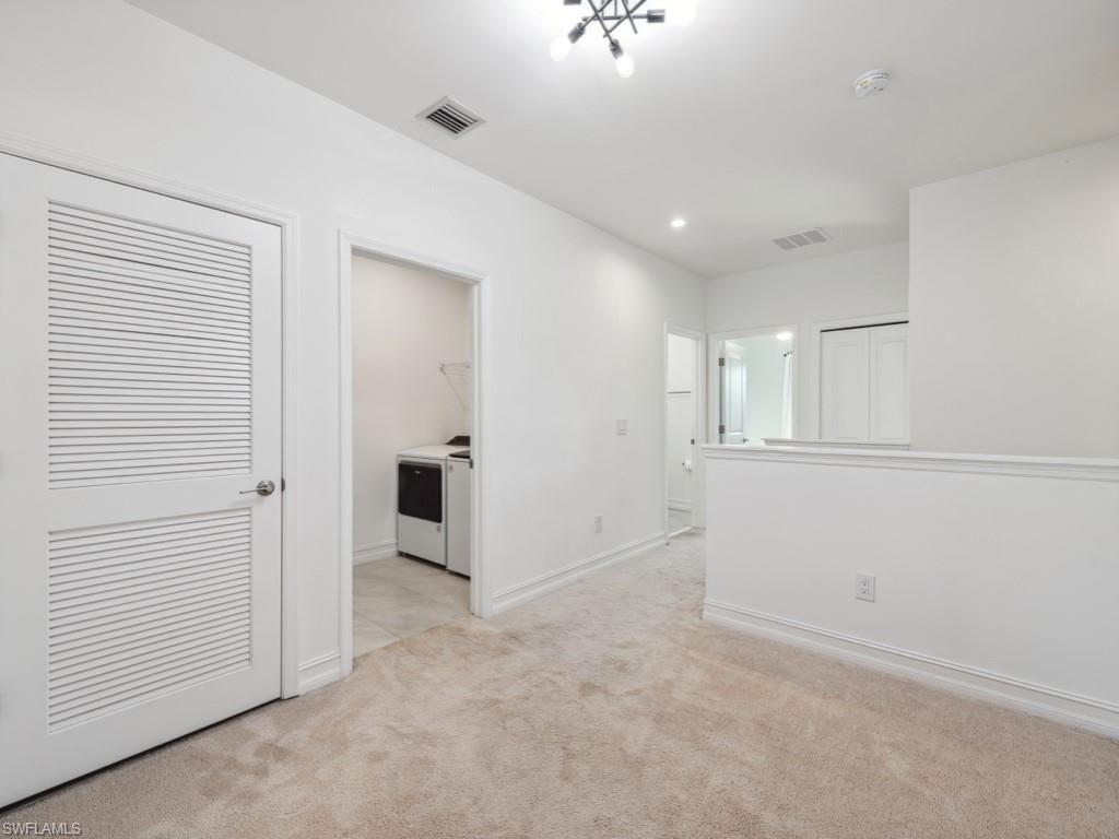 7591 Morgan Way Naples, FL 34119 - Photo 15 of 27 Spare room featuring light colored carpet and washer and clothes dryer