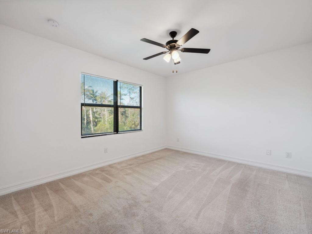 7591 Morgan Way Naples, FL 34119 - Photo 16 of 27 Carpeted empty room featuring ceiling fan