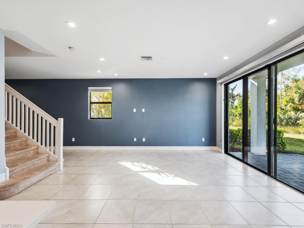 7591 Morgan Way Naples, FL 34119 - Photo 7 of 27 Unfurnished room featuring light tile patterned floors and a wealth of natural light