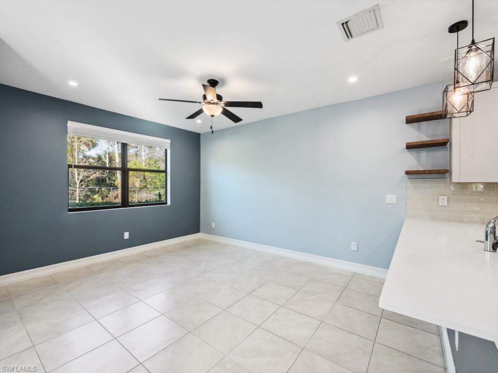 7591 Morgan Way Naples, FL 34119 - Photo 8 of 27 Spare room featuring light tile patterned floors and ceiling fan