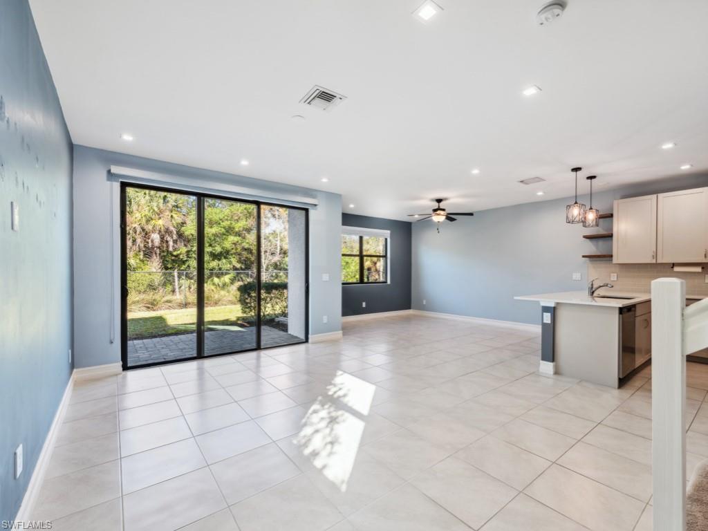 7591 Morgan Way Naples, FL 34119 - Photo 9 of 27 Unfurnished living room with sink, ceiling fan, and light tile patterned flooring
