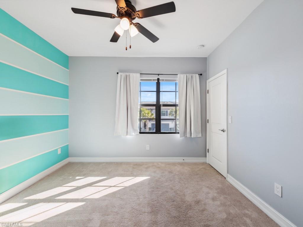 7591 Morgan Way Naples, FL 34119 - Photo 10 of 27 Unfurnished room featuring ceiling fan and light colored carpet
