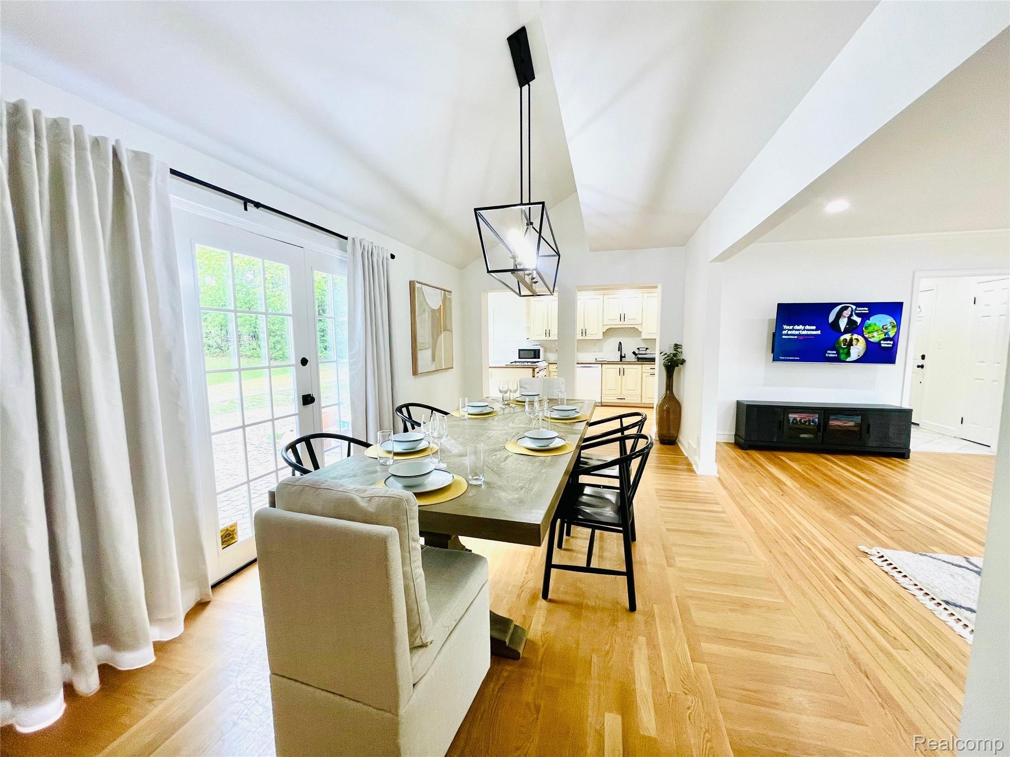 60 Devon Road Bloomfield Hills, MI 48302 - Photo 19 of 50 Bright dining area featuring French doors, a vaulted ceiling, and wood-finish flooring