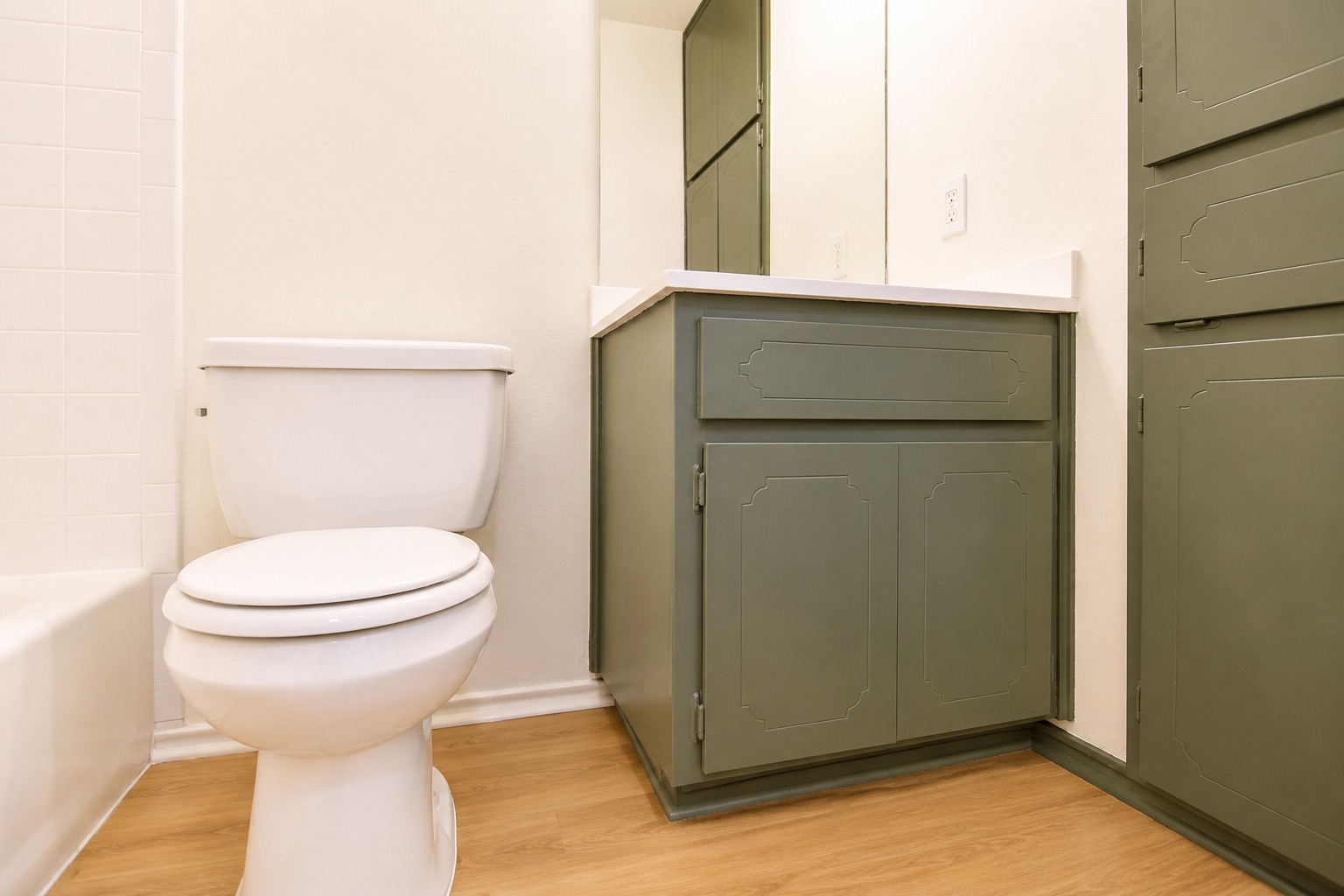 8807 Springmail Circle, Unit A Austin, TX 78729 - Photo 25 of 40 Functional bathroom featuring a toilet, vanity, and ample storage cabinetry.