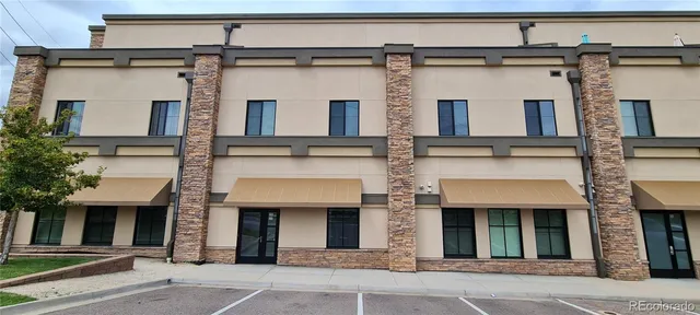 a view of a porch with hardwood and front door