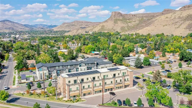 a living room with furniture and view of kitchen