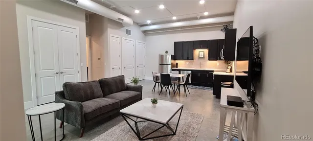 a group of people sitting in living room