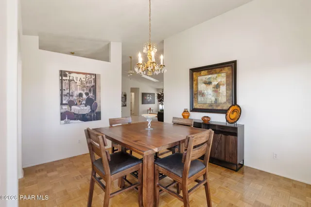 a view of a dining room with furniture and chandelier