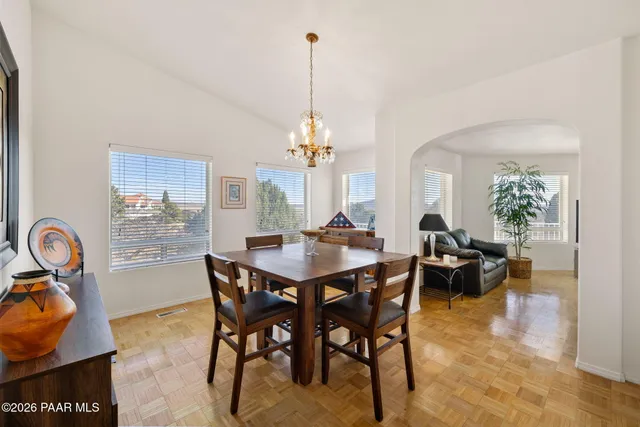 a view of a dining room with furniture and chandelier