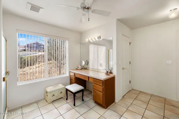 a view of room with workspace and windows