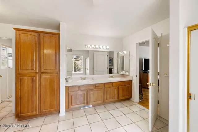 a large bathroom with a sink a mirror and a shower