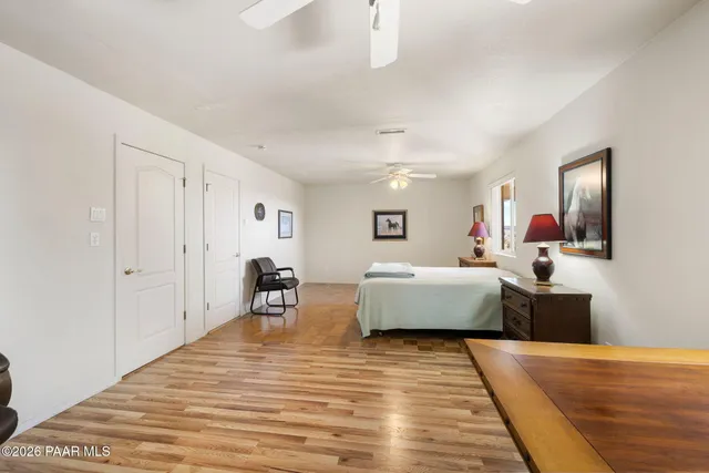 a spacious bathroom with a granite countertop sink a mirror and a shower
