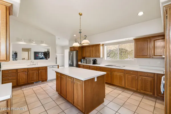 a large kitchen with kitchen island a sink counter space and stainless steel appliances