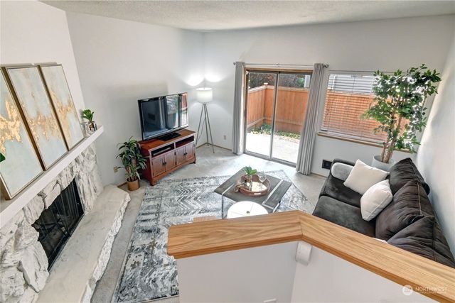 a living room with furniture fireplace and flat screen tv