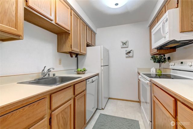 a kitchen with a sink and a refrigerator