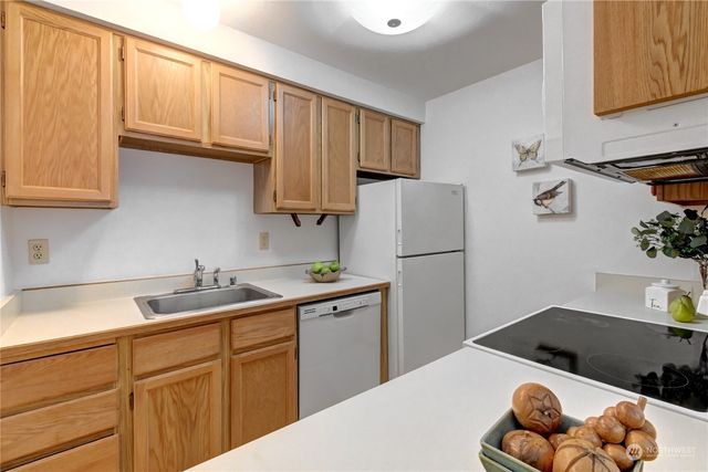 a kitchen with stainless steel appliances granite countertop a refrigerator sink and cabinets